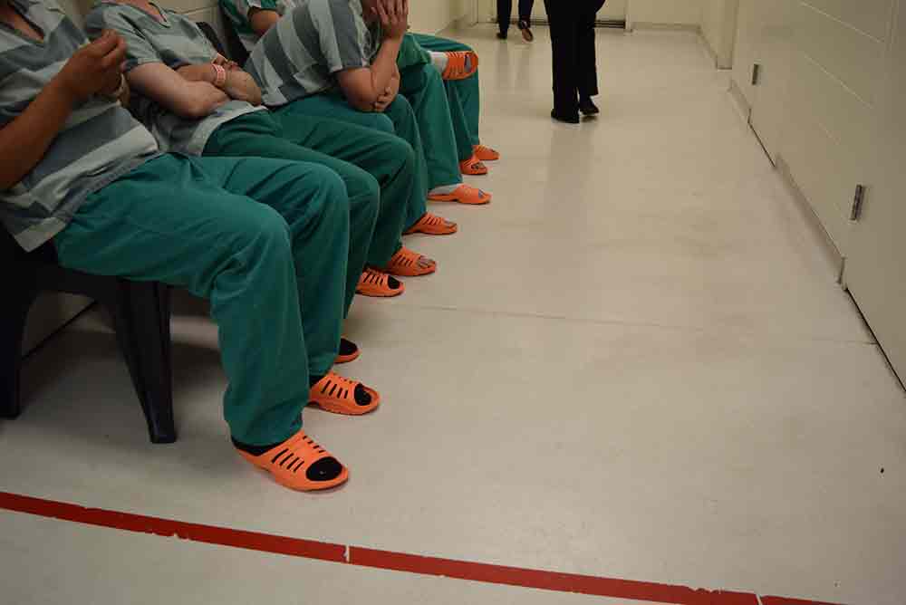 inmates sit wait medical service